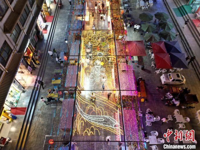 圖為明清街夜市燈光點亮具有武威文化元素的“天梯山石窟”彩燈。(無人機照片) 　戴文昌 攝</p><p>