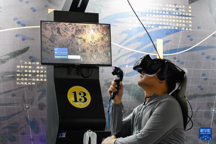 7月22日，游客借助VR設(shè)備沉浸式游覽莫高窟第285窟虛擬場景。新華社記者 郎兵兵 攝